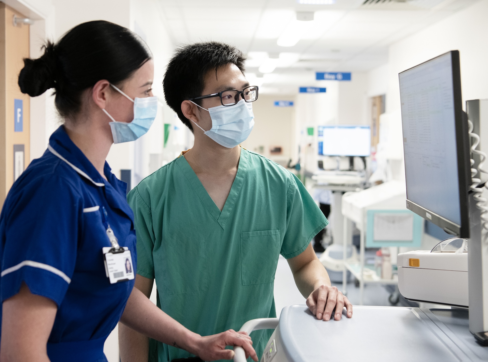 A nurse talking to a doctor at CUH