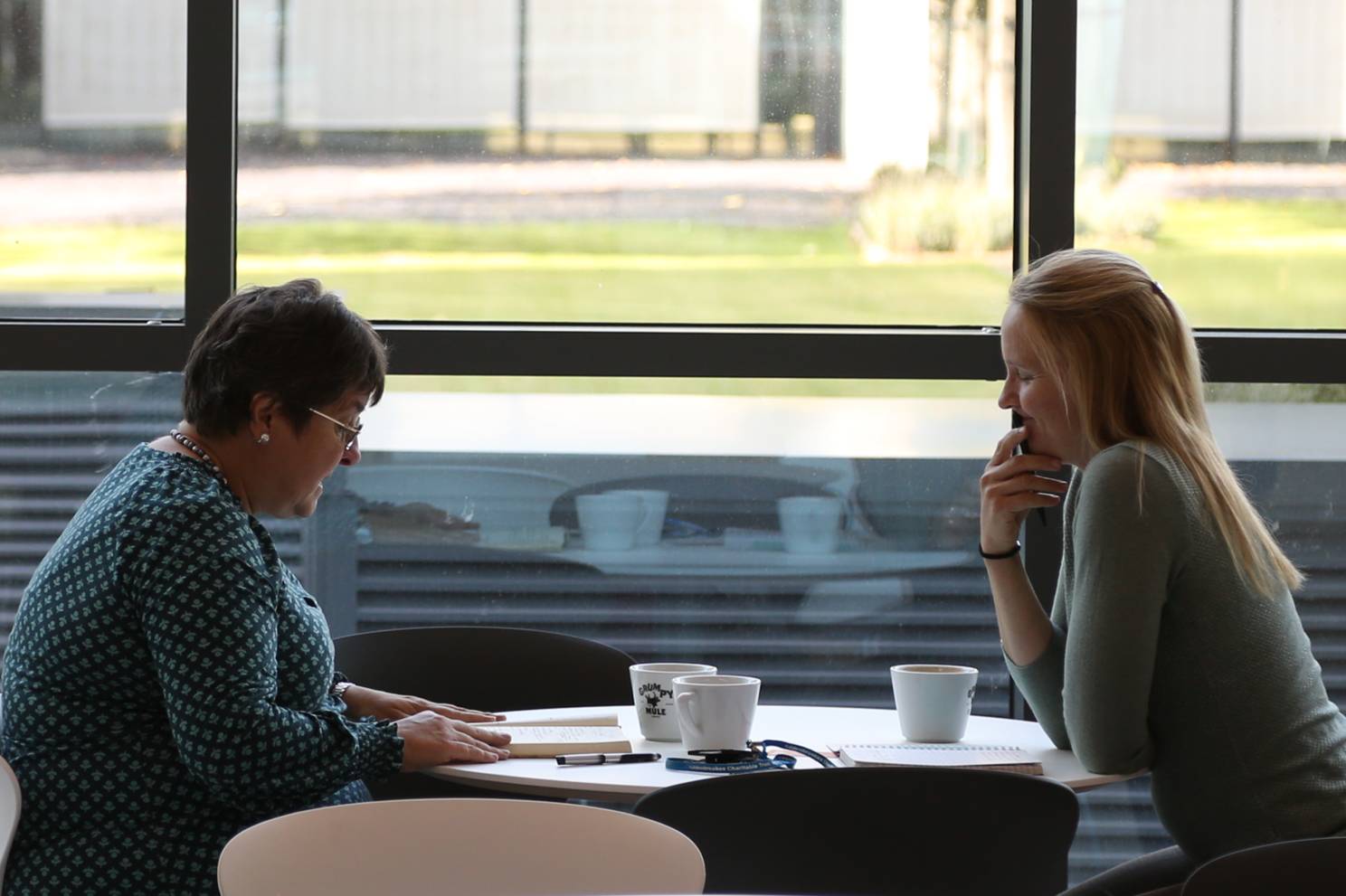 Two people talking in the Milner Cafe