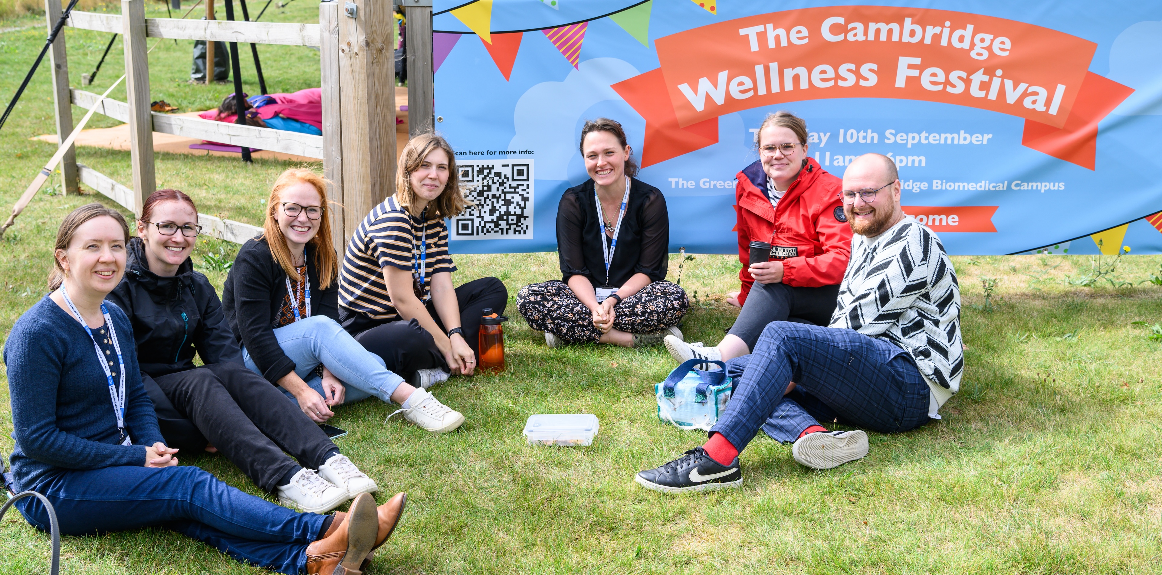 People relax in a group at the Cambridge Wellness Festival