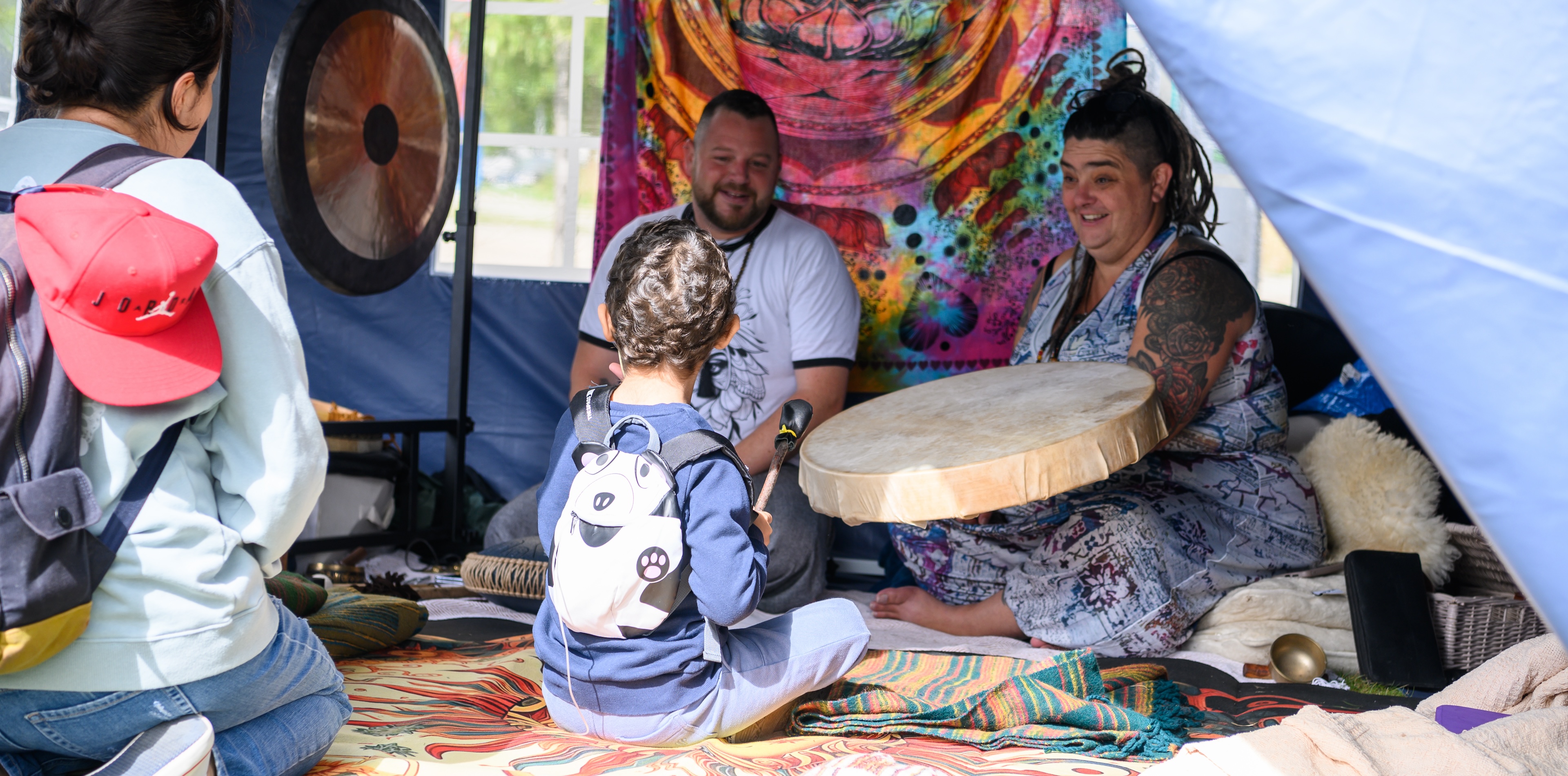 Child plays the drum at the Cambridge Wellness Festival