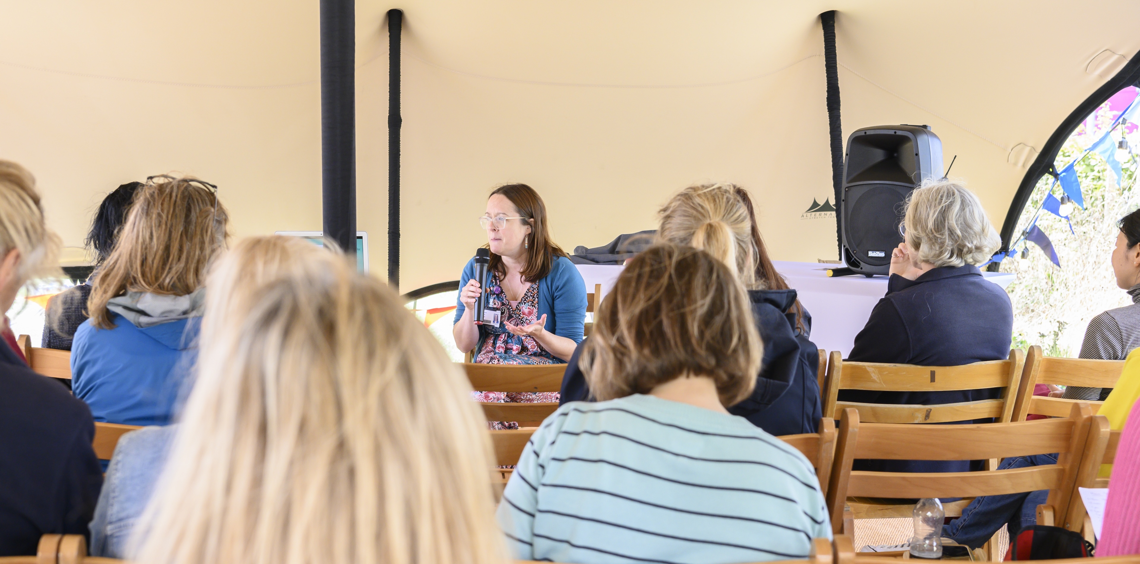 A crowd listens to a talk at the Cambridge Wellness Festival