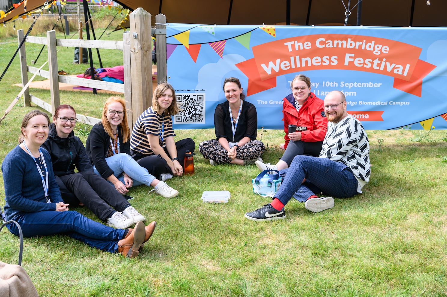 People relax in a group at the Cambridge Wellness Festival