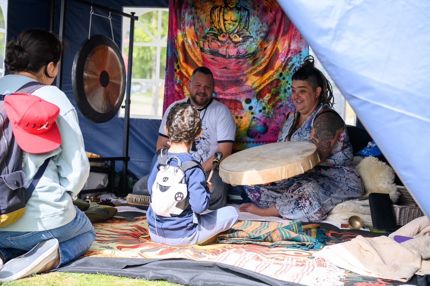 Child plays the drum at the Cambridge Wellness Festival