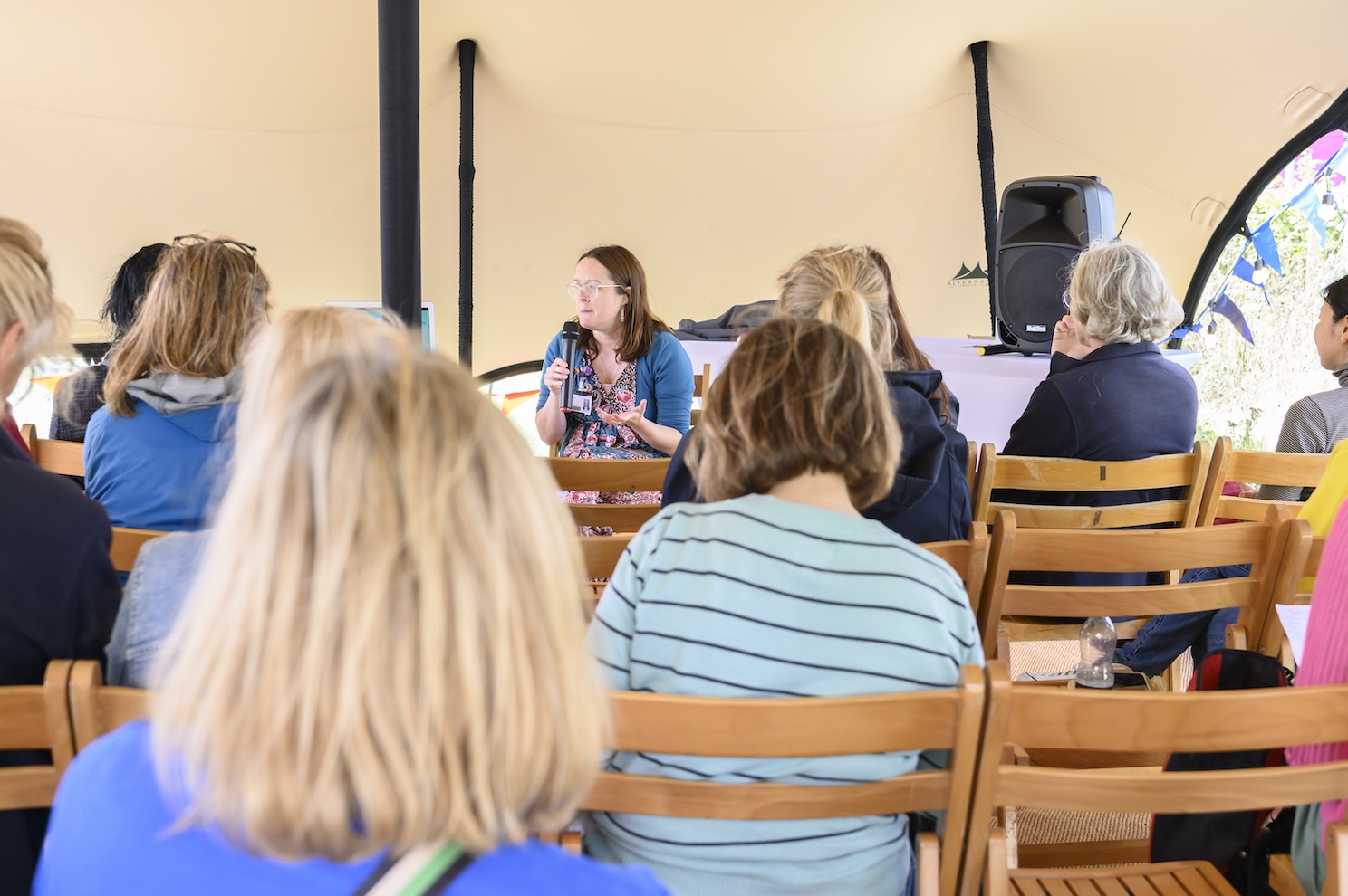 A crowd listens to a talk at the Cambridge Wellness Festival